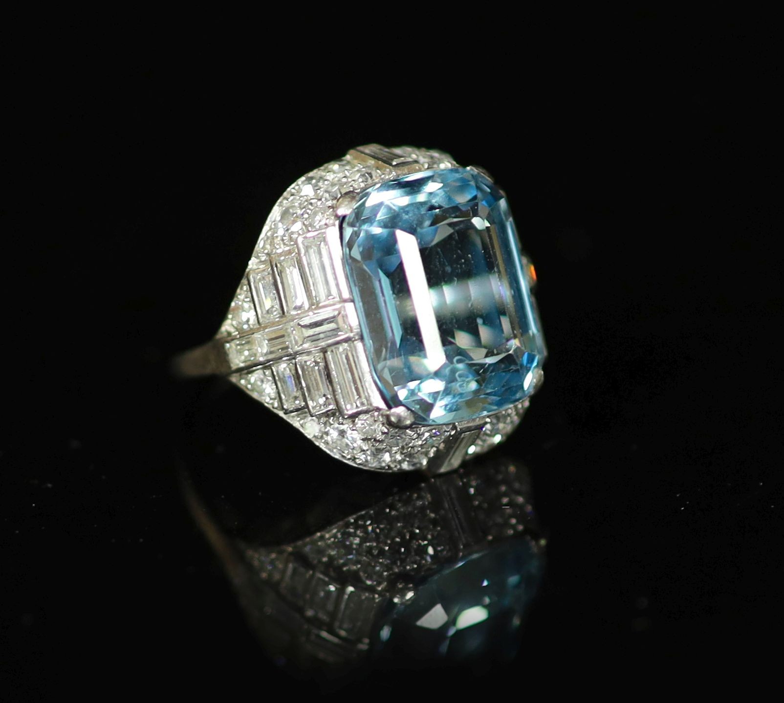 A 1930's/1940's platinum?, emerald cut aquamarine, round and baguette cut diamond set dress ring
